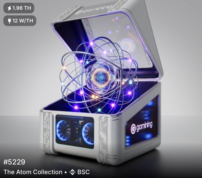 A futuristic white gaming PC case labeled 'gaming' with an atomic model displayed above it, featuring text '1.96 TH', '12 W/TH', '#5229', and 'The Atom Collection - BSC'.