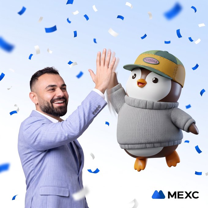 A smiling man in a light blue suit gives a high-five to a cartoon penguin mascot wearing a "PERSONA" cap and gray sweater, with blue and white confetti raining down against a light background, alongside the "MEXC" logo in the bottom right corner—celebratory imagery marking the new MEXC CEO's 100-day milestone.