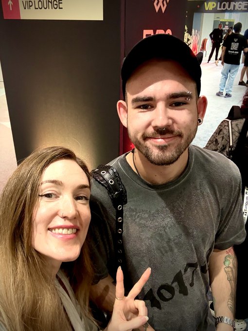 A fan poses for a selfie with a smiling, cap-wearing DJ making a peace sign inside a "VIP LOUNGE," with "EDC" signage visible in the background, promoting tonight's rave set mentioned in the post.