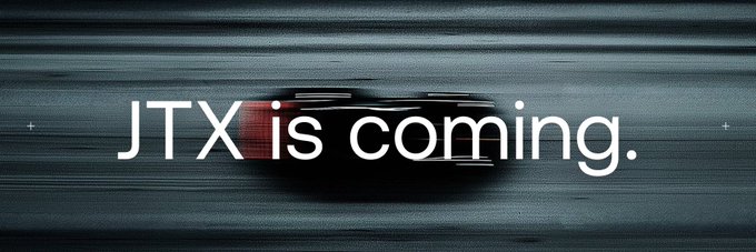 A sleek, motion-blurred image of a car with the text 'JTX is coming.' overlaid, suggesting an upcoming announcement related to JTX.