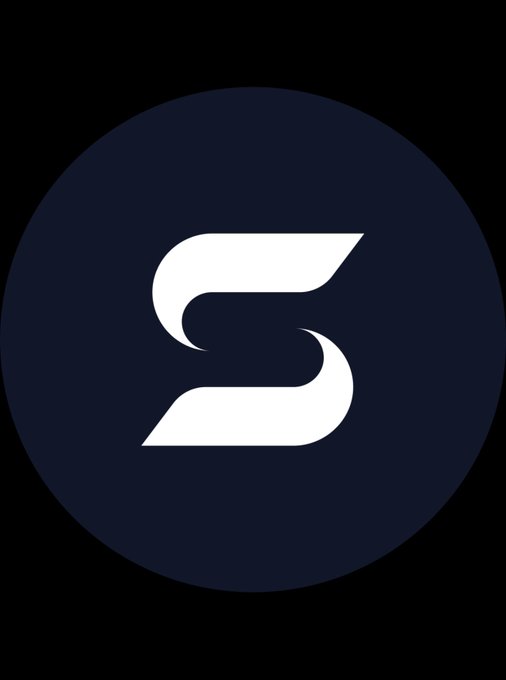 A dark navy circular logo featuring a stylized white "S" formed by two curved swooshes, representing the SURF Cardano brand. The minimalist emblem aligns with the post's message about surfacing real profits over hype, visually echoing the project's name and clean, profit-focused identity.