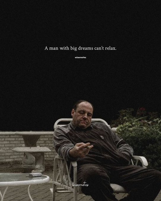 Dark, cinematic image of a man (resembling Tony Soprano) sitting in a patio chair holding a cigar, with the quote 'A man with big dreams can't relax.' and watermark 'wisemoies'.