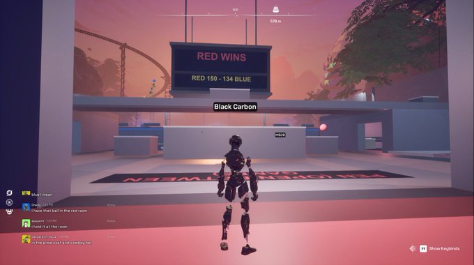 A character in a video game stands in an arena while a scoreboard displays "RED WINS" with the score "RED 150 - 134 BLUE," and the username "Black Carbon" is visible above the character.