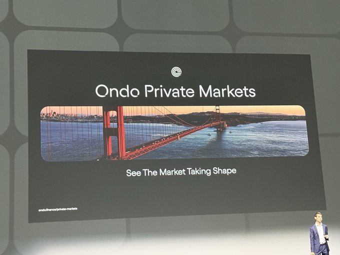 A presenter stands on stage in front of a large presentation screen for 'Ondo Private Markets' displaying the Golden Gate Bridge with the tagline 'See The Market Taking Shape'.