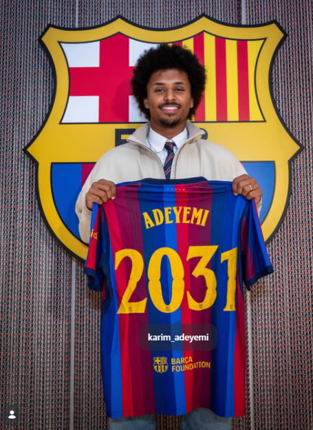A young man with curly hair smiling and holding up a FC Barcelona jersey with 'ADEYEMI 2031' on it, credited to karim_adeyemi.