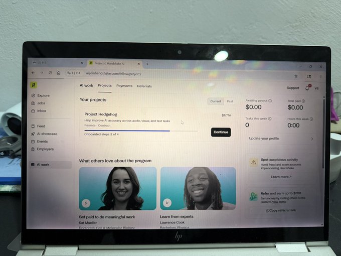 A laptop screen displaying the joinhandshake.com/fellow/projects page, showing a 'Project: Hedgehog' listing for $107/hr under the 'AI work' tab.