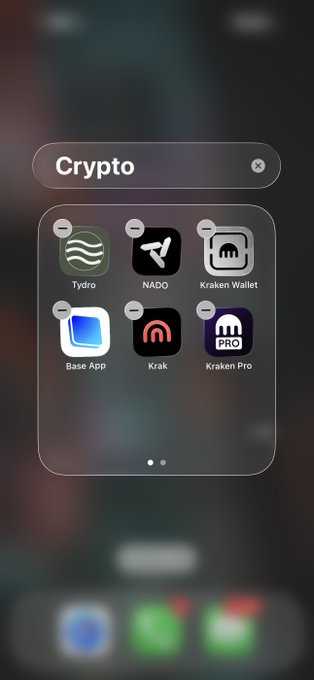 A smartphone home screen showing a Crypto folder containing app icons labeled 'Tydro', 'NADO', 'Kraken Wallet', 'Base App', 'Krak', and 'Kraken Pro'.