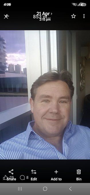 The image shows a man in a blue and white striped shirt taking a selfie, with the metadata "21 Apr 853.0" and "2:15 pm" visible. The caption "We are so close my friends. Have a great day. Your lives are about to change. #XRP" connects the image to anticipation of a major Ripple (XRP) cryptocurrency event or price surge.