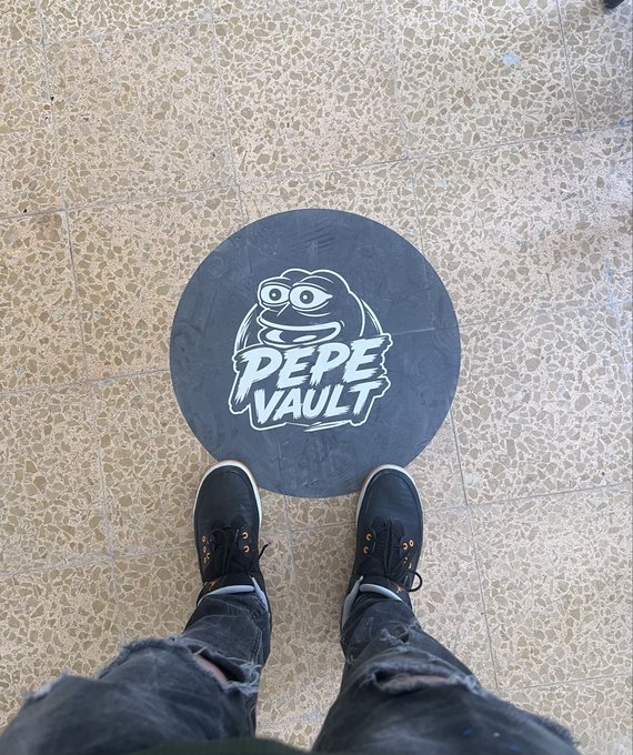 A person stands with black sneakers over a circular black floor decal featuring Pepe the Frog with the text "PEPE VAULT," visually representing the post's reference to Pepe.