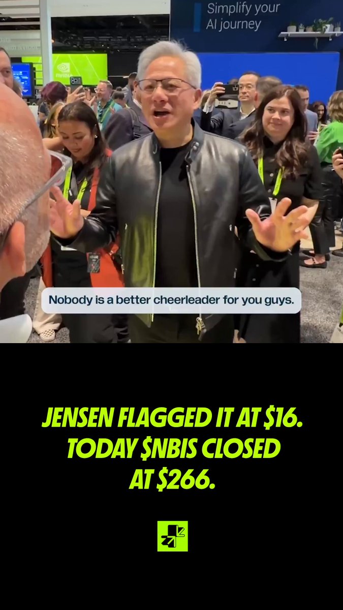 The image shows a man wearing glasses and a black leather jacket with his hands up as he speaks into a microphone at an event, possibly announcing the price of the stock when it was $16. The image also features the text "nobody is a better cheerleader for you guys", which may have been a joke or part of a promotional post about Jensen Huang and the trading strategy for the stock. Additionally, there is information that suggests the price of the stock being $266 today at around $265.