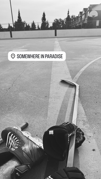 A black-and-white photo shows a hockey player's gloved hand gripping a stick on an outdoor court, with a "SOMEWHERE IN PARADISE" location sticker overlay—capturing the laid-back vibe of a morning "Gm" check-in.