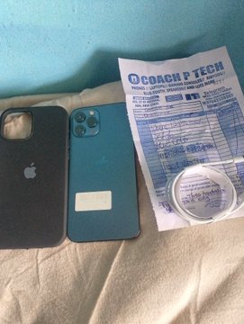 The image shows two iPhones (one black and one teal/dark green) laid on a bed next to an "ECOACH P TECH" document/handout, which appears to be a crypto or tech training certificate referencing Bitcoin and cryptocurrency topics. The post's message "iPhone is not an achievement, but try and have it" aligns with the image by showcasing iPhones as status symbols, while the Web3/God reference connects to the ECOACH P TECH crypto-related document beside them, suggesting the user values both material tech success and spiritual/digital innovation.
