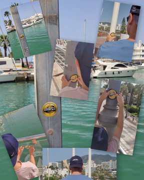 A person places a circular "SPX" sticker on various surfaces including a boat railing and post at a sunny marina in Benalmádena, Malaga, while a child in a cap assists, reflecting the post's theme of finding SPX6900 sticker spots during a family vacation in Spain.