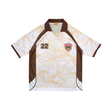 A short-sleeved polo shirt with cream, brown, and tan patterns displays the number '22' and a small emblem on the chest.