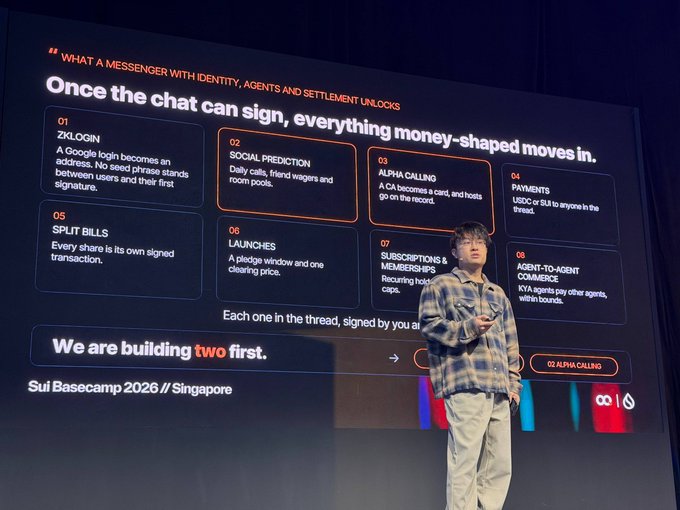 A presenter on stage at 'Sui Basecamp 2026 // Singapore' explaining a slide titled 'WHAT A MESSENGER WITH IDENTITY, AGENTS AND SETTLEMENT UNLOCKS' with numbered features like ZKLOGIN and SOCIAL PREDICTION.