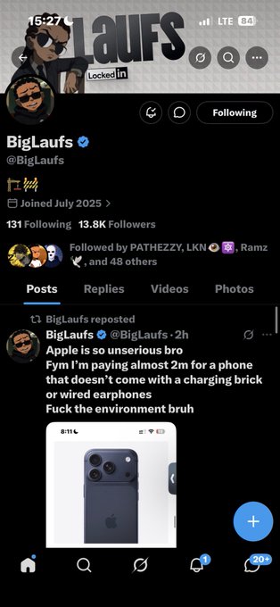 A screenshot of a Twitter/X profile for 'BigLaufs' (@BigLaufs) with 13.8K Followers, reposting a tweet that reads 'Apple is so unserious bro Fym I'm paying almost 2m for a phone that doesn't come with a charging brick or wired earphones Fuck the environment bruh' alongside an image of an iPhone.
