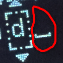 A close-up of a Coldcard Mk hardware wallet screen displays a partially entered passphrase with a circled, unwanted trailing space character appearing after the "L" before finalization. The image illustrates a common pitfall when setting a passphrase, highlighting the subtle space symbol that could unknowingly alter the wallet's fingerprint.