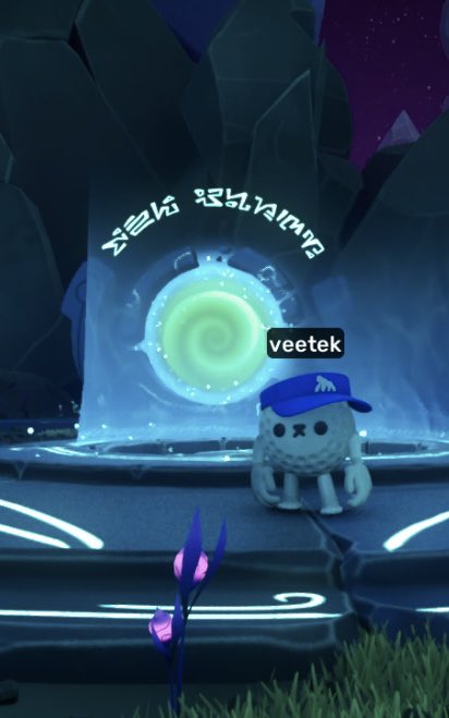 A video game scene shows a small white creature with a blue cap labeled 'veetek' standing near a glowing blue portal in a dark, crystalline environment.