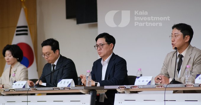Four people seated at a press conference table for Kaia Investment Partners, with the South Korean flag visible in the background.