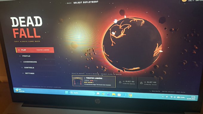 A photograph of an HP laptop screen displaying the main menu of the video game 'Dead Fall' with options to Play, Profile, Leaderboard, Controls, and Settings.