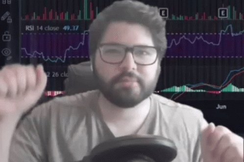 iced coffee with a straw, a man's hand holding a cup of coffee, and a computer screen displaying stock market data.