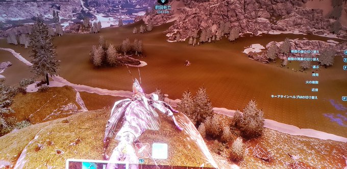 A first-person view from a video game showing a character gliding over a snowy, mountainous landscape with Japanese text labels and a minimap.