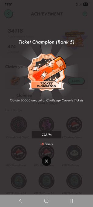 A mobile app achievement screen displaying "Ticket Champion (Rank 5)" with a badge graphic, noting the requirement of obtaining 10000 amount of Challenge Capsule Tickets, with various other event badges visible.