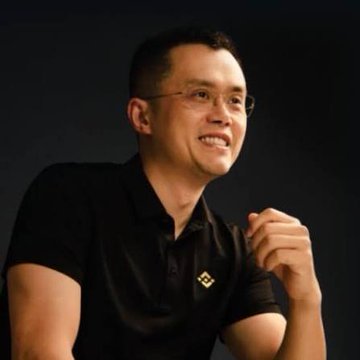 Changpeng Zhao (CZ), founder of Binance, smiles during an interview, aligning with his quoted philosophy of long-term holding rather than active trading or market timing.