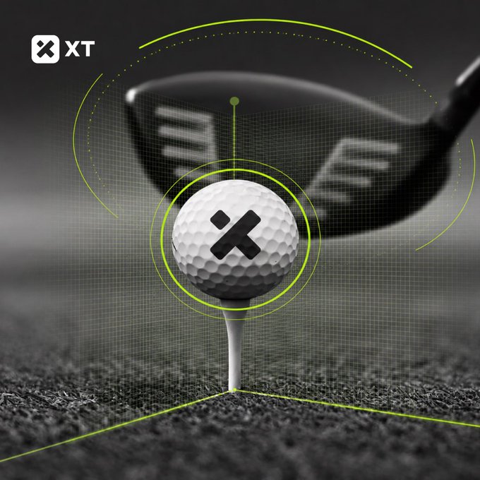 A golf ball sits atop a tee in the foreground, marked with a bold black "X" logo, while a blurred driver club looms in the background, framed by green targeting graphics and the text "XT" in the upper left corner, visually reinforcing the post's theme of precision and focus as it ties the metaphor of "eyes on the target" to the XTexchange crypto call.