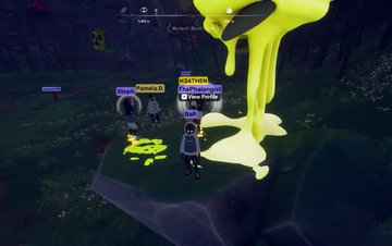 The image shows a group of people standing together in front of a large, yellow object that appears to be dripping with liquid or paint. There are at least five individuals visible in the scene, each positioned at different angles around the object. One person is located on the left side of the image, while another stands closer to the right side. The remaining three people are situated more towards the center and back of the frame. 

The large yellow object seems to be the main focus of the group's attention, with its dripping or splashing nature drawing their interest. The overall atmosphere appears to be casual and friendly as they gather around this intriguing sight.
