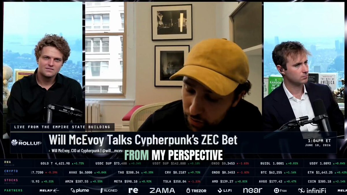 In this image, there are three men sitting around a table with their heads down. They appear to be engaged in a serious discussion or working together on something related to technology. The background of the image features a television screen displaying a news segment about the vulnerability of the Zcash cryptocurrency. This news segment highlights how the vulnerability has been identified and emphasizes the importance of community involvement in addressing such issues.