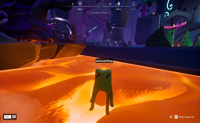 A screenshot from a video game showing a green frog-like character labeled "iamcarlitos" standing on orange terrain in the "Obsidian Biome."