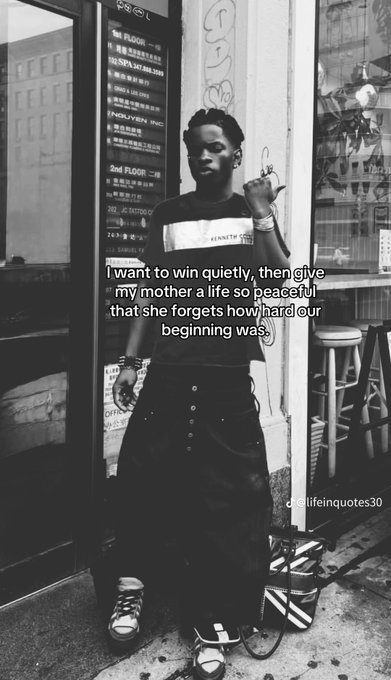 A black and white photo of a stylish young man standing in front of a directory sign features the overlaid quote: 'I want to win quietly, then give my mother a life so peaceful that she forgets how hard our beginning was.' credited to 'deeplifequotes30'.