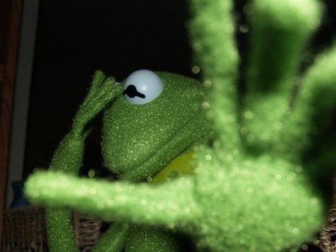 A glittery green Kermit the Frog figurine peers through foliage with a wide-eyed, almost contemplative expression, perfectly capturing the "I have no choice but to make it" hustle mindset described in the caption—turning the meme into a symbol of entrepreneurial determination in the NFT/crypto space.