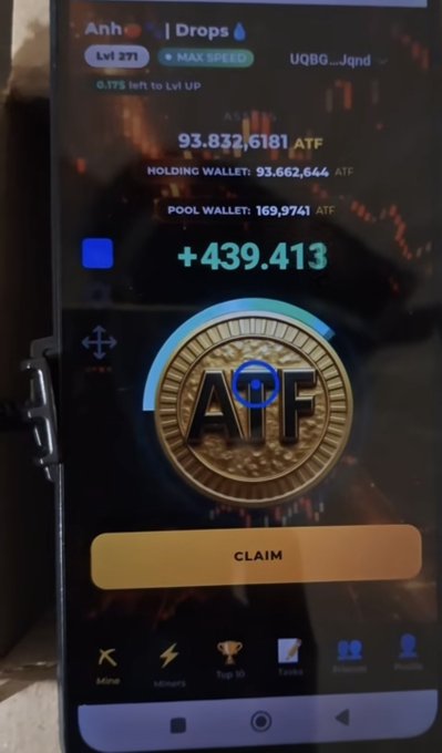A smartphone screen displays a crypto-mining app interface showing 'Anh Drops' with '+439.413' and a coin labeled 'ATF' above a 'CLAIM' button.