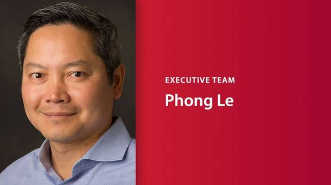 A professional headshot of a smiling man in a light blue shirt, displayed on a red background with the text 'EXECUTIVE TEAM' and 'Phong Le'.