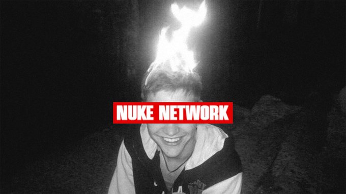 A black-and-white photo shows a smiling young boy whose head appears to be on fire, with the red text 'NUKE NETWORK' stamped across his face.