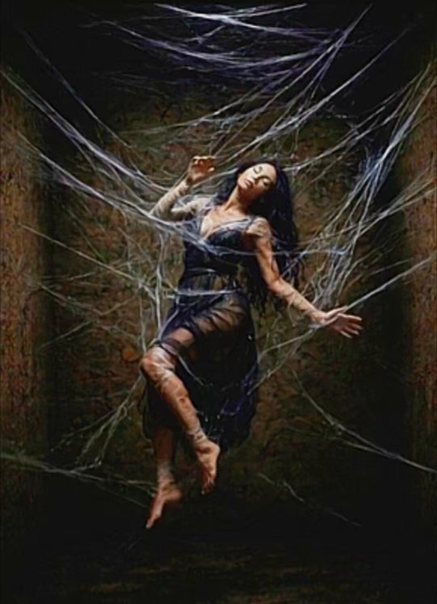 The image features a woman wearing a black dress with her arms outstretched as if she's floating or suspended in mid-air. The background of the photo is dark, creating an atmosphere that complements the woman's pose. There are no other objects or people visible in the image, and it seems to be a standalone post on social media.