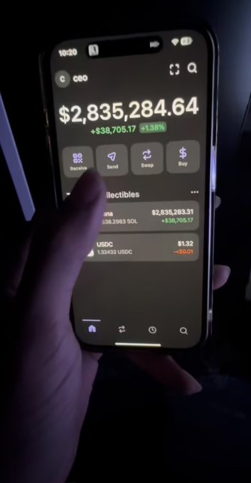 A hand holds a smartphone displaying a crypto wallet app (likely Coinbase) showing a balance of $2,835,284.64 with a +$38,705.17 (+1.38%) gain, along with holdings in SOL and USDC. The image appears to support the post's claim of a large crypto balance, likely meant to lend credibility to the giveaway offer soliciting SOL addresses.