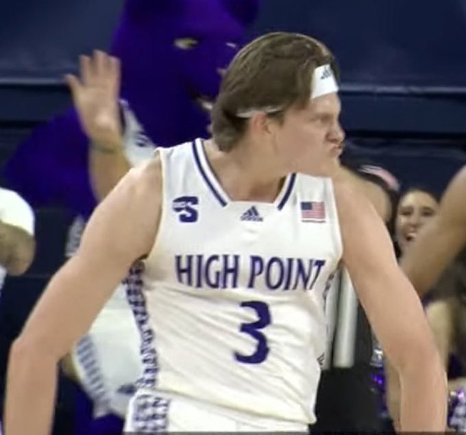 A High Point University basketball player wearing jersey #3 with an Adidas logo and American flag patch, standing on the court during a game.