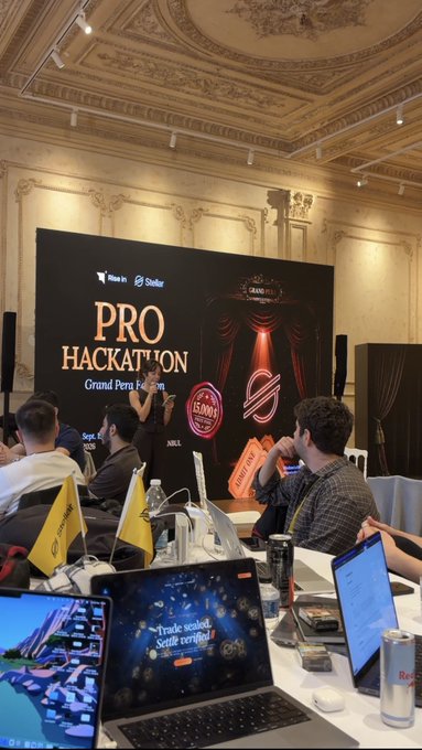A hackathon event called 'PRO HACKATHON' held at the Grand Pera venue, showing attendees with laptops including one displaying a 'Trade seçenek! Şimdi sertifika' advertisement.
