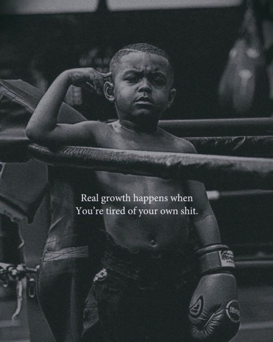 A black and white photo of a young boy in a boxing ring wearing gloves, with text overlay reading 'Real growth happens when You're tired of your own shit.'