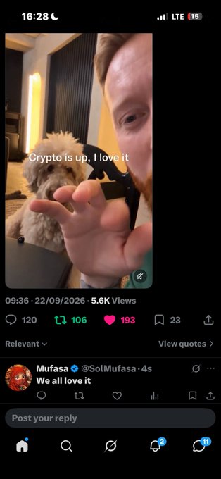 A Twitter/X post featuring a man holding a small dog with the caption 'Crypto is up, I love it' overlaid on the image.