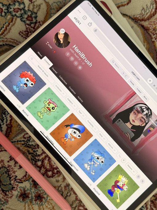 A tablet displaying an NFT marketplace called 'objkt' showing the 'Hanibrush' collection with various cartoon character artworks and a price of 2.4 tez.