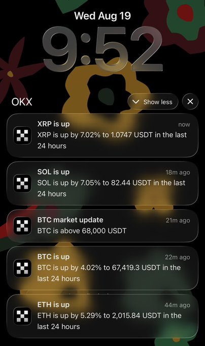A smartphone lock screen showing the time 9:52 on Wed Aug 19 with cryptocurrency notifications from OKX showing XRP up 7.02%, SOL up 7.05%, BTC above 68,000 USDT, BTC up 4.02%, and ETH up 5.29%.