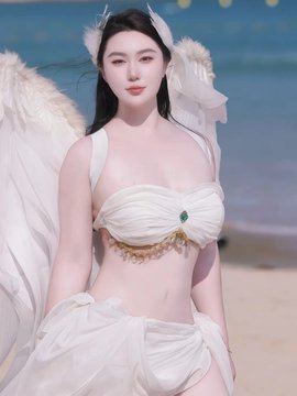 A woman dressed as an angel with white feathered wings, a white bandeau top featuring a green gem, and a flowing white skirt stands on a sandy beach.