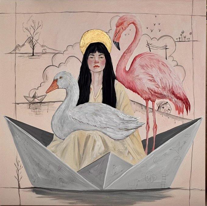 A young woman with a golden halo and dark hair sits inside an oversized paper boat, flanked by a white swan on her lap and a tall pink flamingo, all set against a dreamy pink backdrop featuring sketched mountains, clouds, a small house, a paper boat in water, power lines, and birds, while the boat itself is decorated with faint doodles of moons, flowers, and figures—evoking a whimsical, surreal 80s-inspired folk art aesthetic that matches the playful, lo-fi vibe of the artist's post.