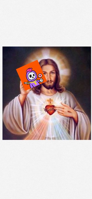 A religious painting of Jesus holding a Sacred Heart, with a cartoon skeleton sticker on an orange card placed over his right hand.
