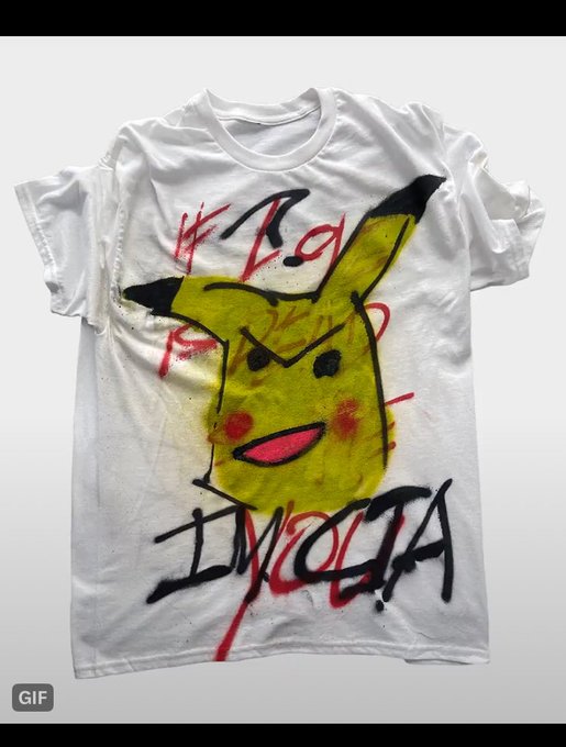 A white t-shirt displayed against a grey background features a painted Pikachu design with the word 'IKIGAI' crossed out in red and replaced with 'IKIGUOTA' in black spray paint.