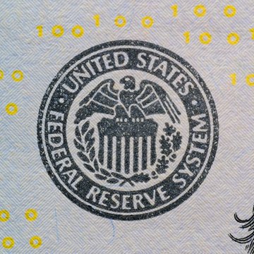 The image shows the seal of the United States Federal Reserve System, overlaid with scattered binary code (1s and 0s), symbolizing the intersection of traditional central banking and digital/cryptocurrency markets. The post highlights the Fed's updated dot plot delaying expected rate easing through 2027, which impacts Bitcoin's liquidity conditions.